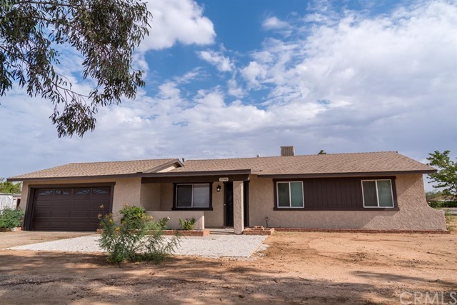 21540 Tussing Ranch Road Apple Valley, CA 92308 - Photo 1 of 1 a front view of a house with a yard and garage