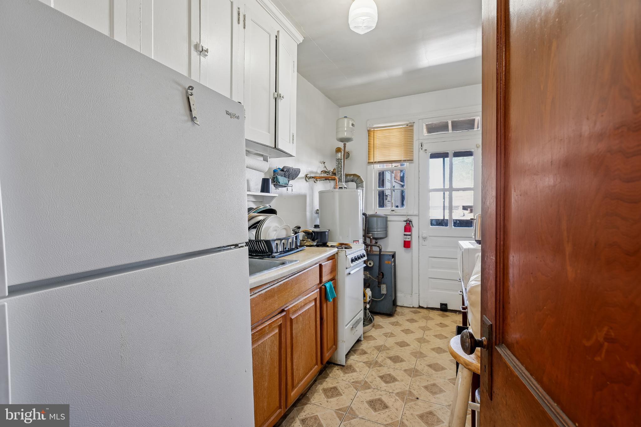 5618 1st Street Northwest Washington, DC 20011 - Photo 11 of 18 a storage room with cabinets washer and dryer