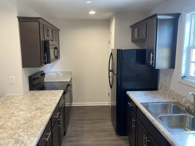a kitchen with a refrigerator and a sink
