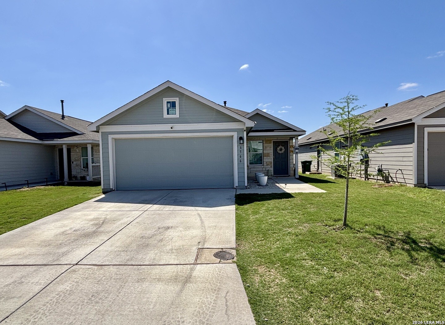 6566 Runaway Row Converse, TX 78109 - Photo 3 of 27 a front view of a house with a yard and garage