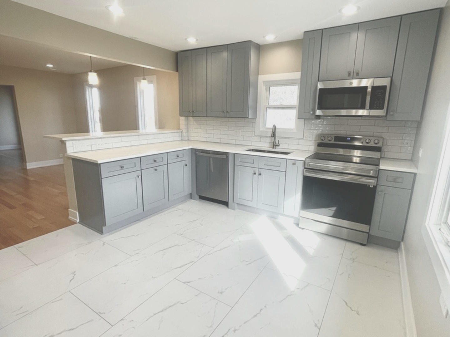 26073 West Grand Avenue Ingleside, IL 60041 - Photo 15 of 36 a large white kitchen with cabinets