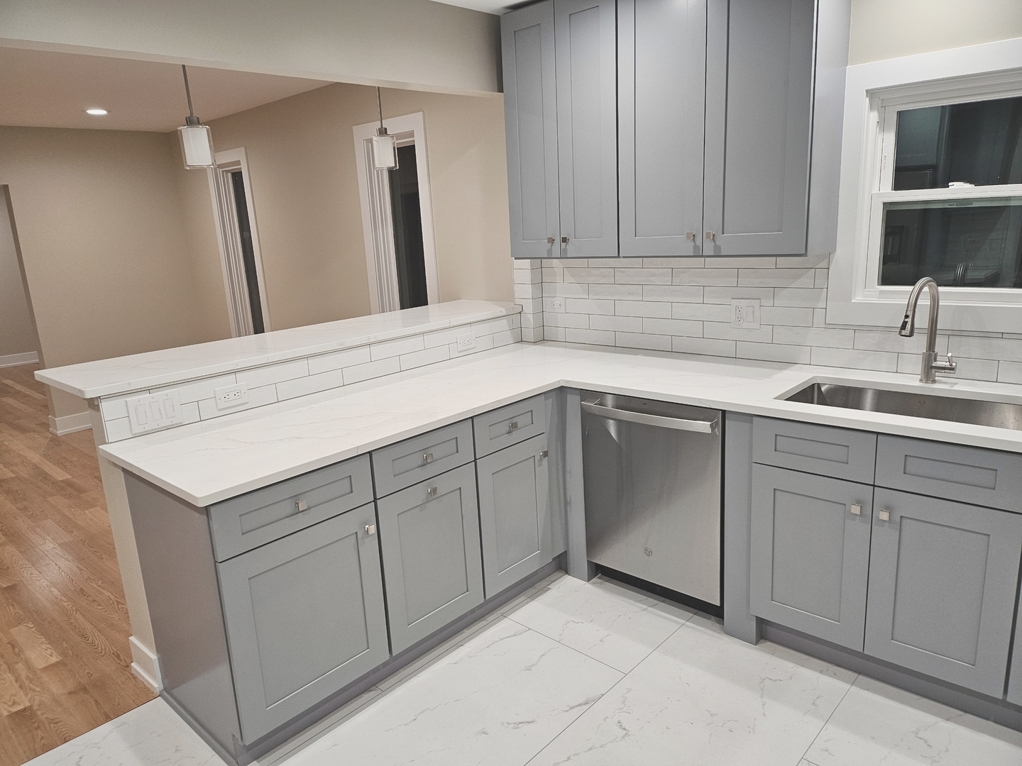 26073 West Grand Avenue Ingleside, IL 60041 - Photo 16 of 36 a kitchen with white cabinets sink and dishwasher