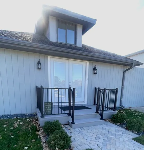 a view of a house with a wooden fence
