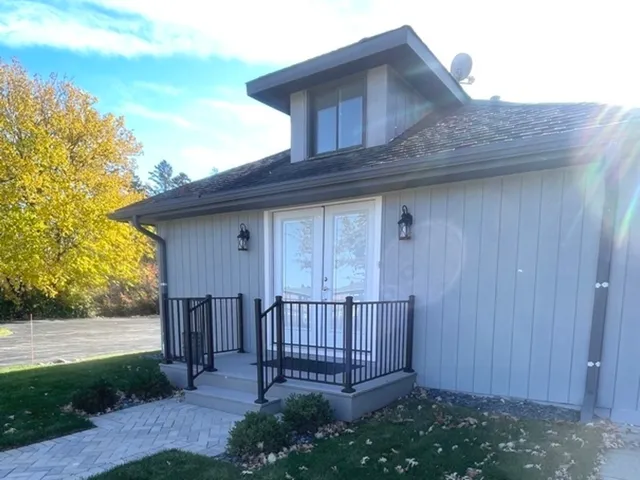 a view of backyard with potted plants and wooden fence