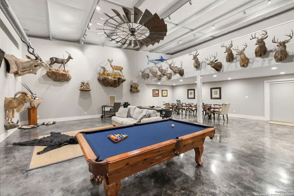 a room with gym equipment and view of chandelier