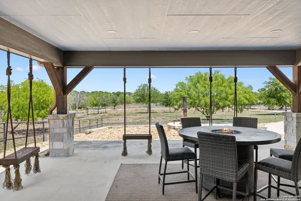 a view of a patio with table and chairs under an umbrella
