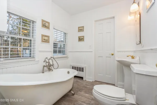 a white bath tub sitting next to a white toilet