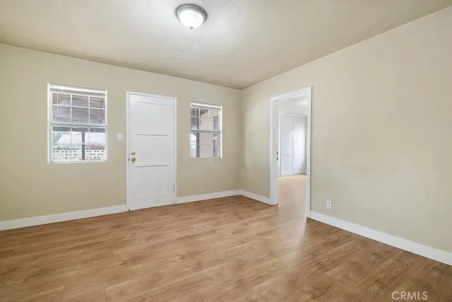 an empty room with windows and closet