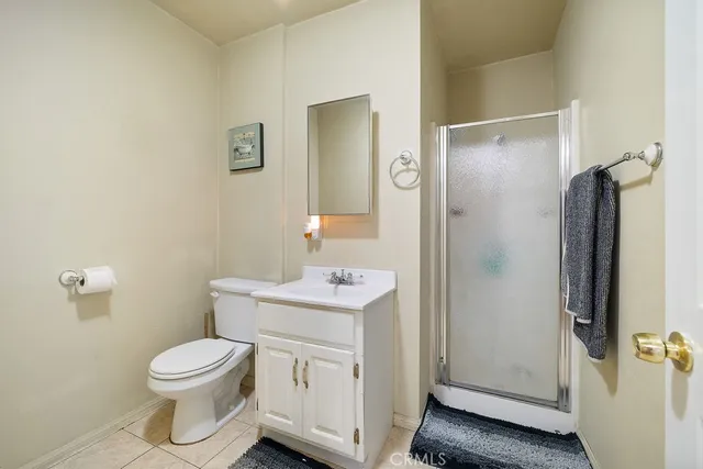 a bathroom with a toilet a sink and shower