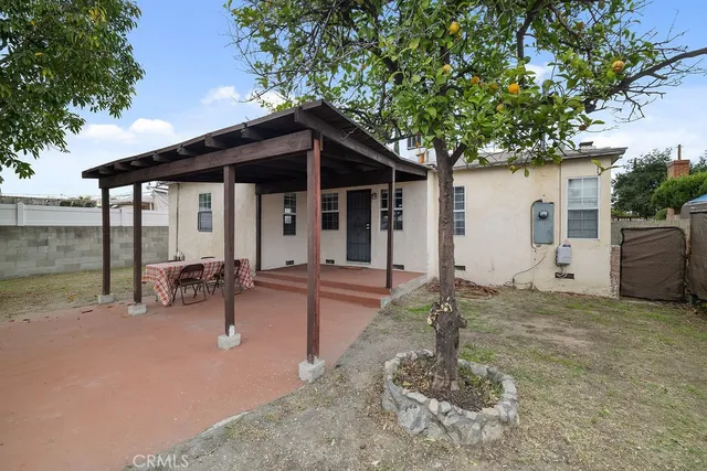 a backyard of a house with table and chairs