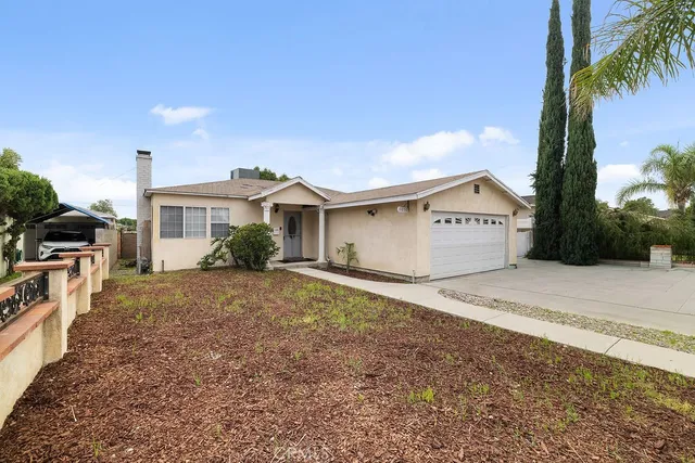 a view of a house with palm trees