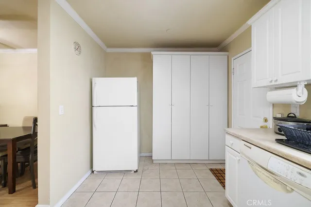 a utility room with cabinets washer and dryer