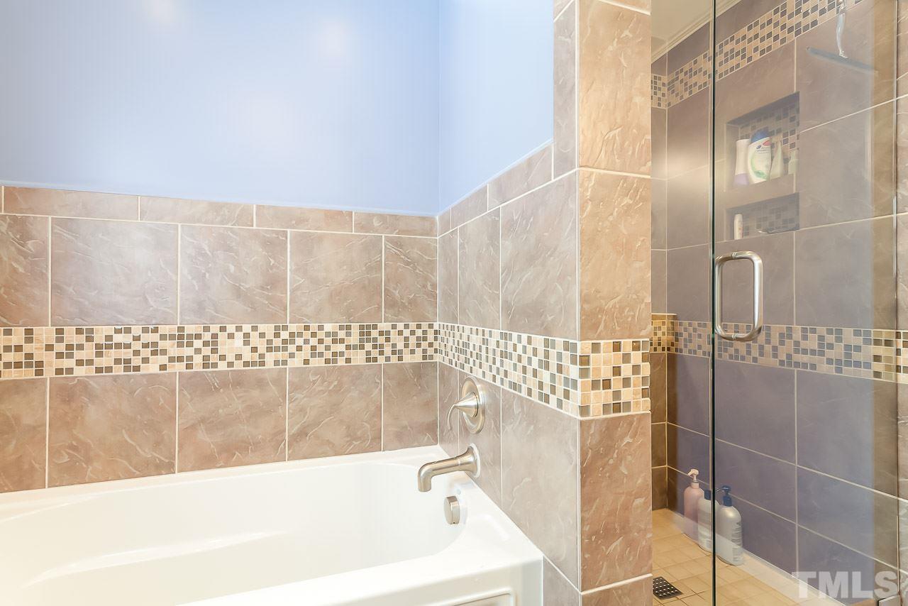 2518 Beechridge Road Raleigh, NC 27608 - Photo 12 of 25 a bathroom with a bathtub and shower