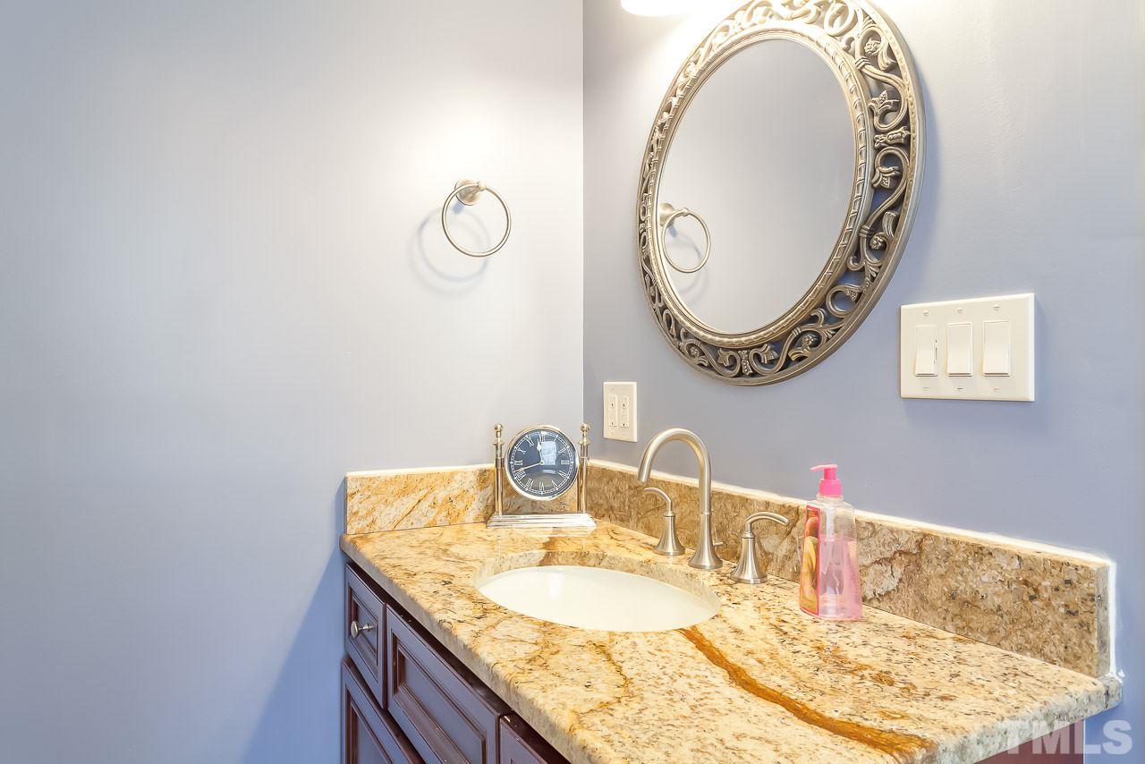 2518 Beechridge Road Raleigh, NC 27608 - Photo 13 of 25 a bathroom with a granite countertop sink and a mirror