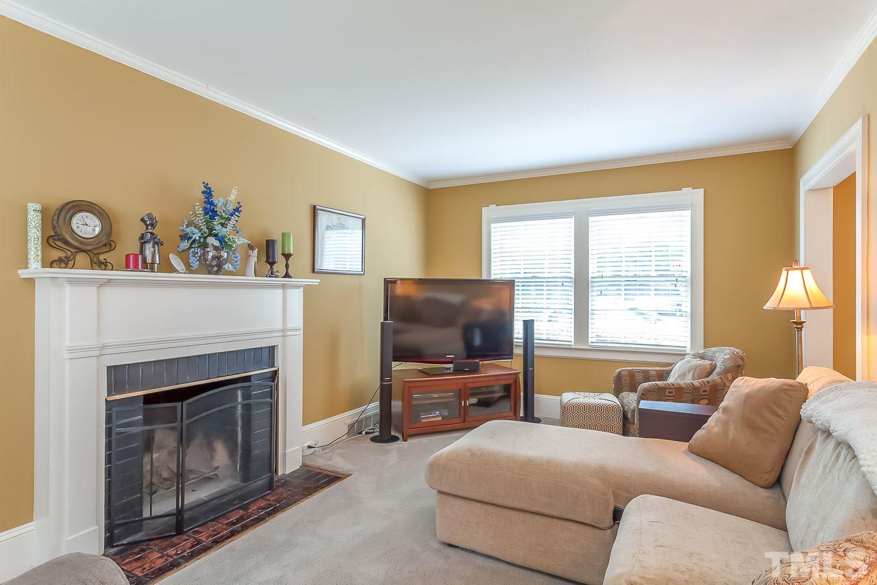 2518 Beechridge Road Raleigh, NC 27608 - Photo 3 of 25 a living room with furniture and a flat screen tv
