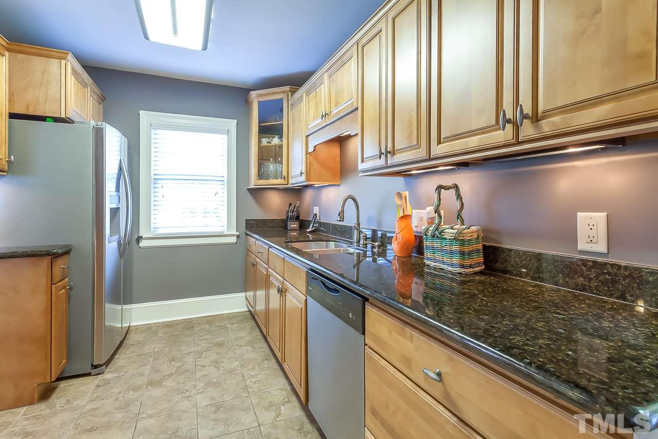 2518 Beechridge Road Raleigh, NC 27608 - Photo 5 of 25 a kitchen with granite countertop stainless steel appliances a sink a refrigerator and cabinets