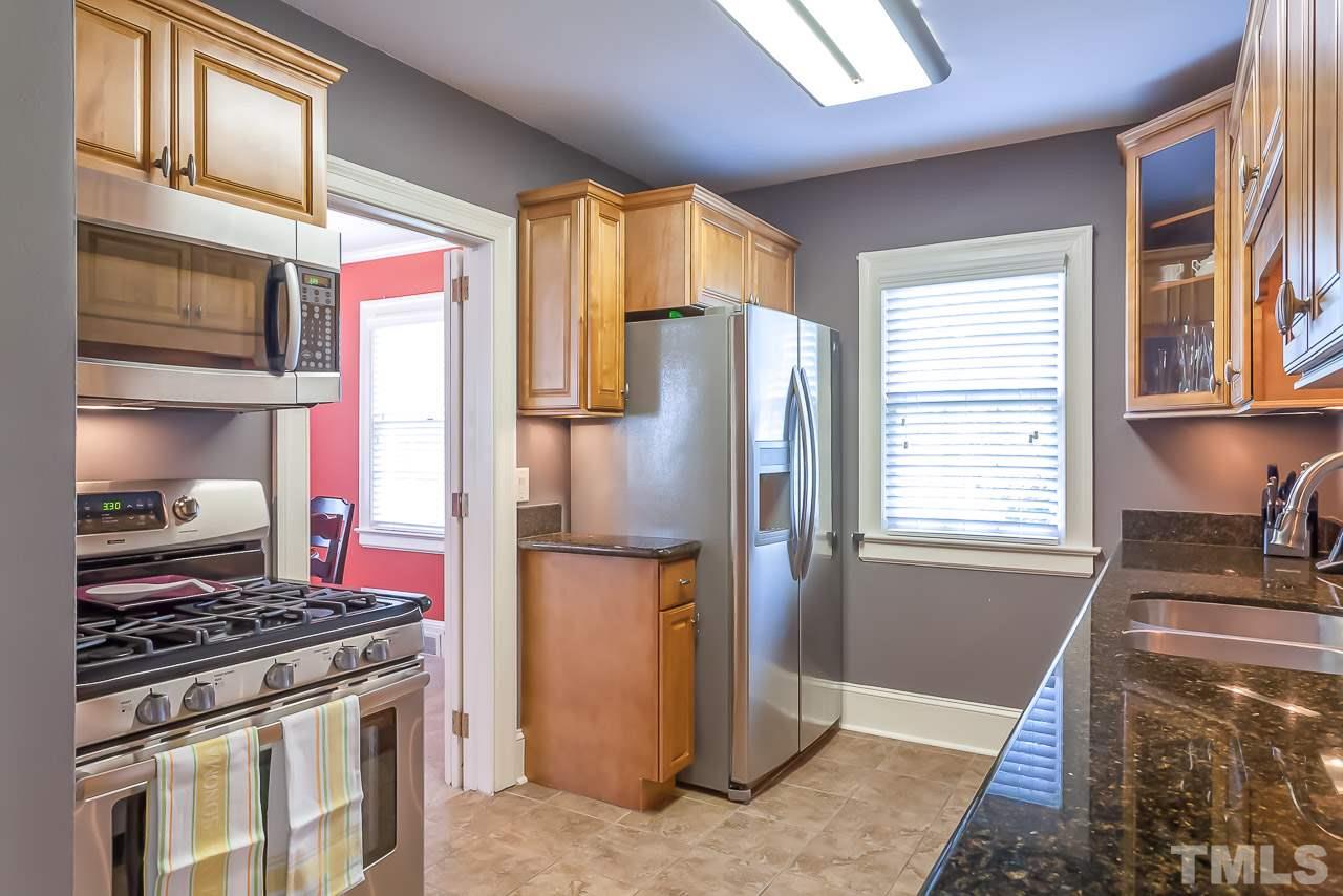 2518 Beechridge Road Raleigh, NC 27608 - Photo 6 of 25 a kitchen with stainless steel appliances granite countertop a stove a refrigerator and a stove