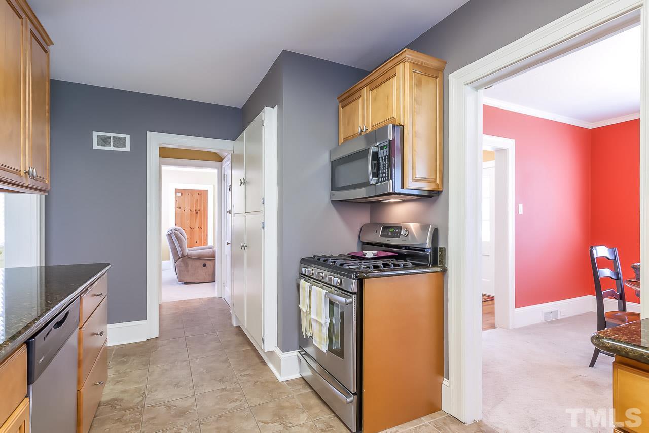 2518 Beechridge Road Raleigh, NC 27608 - Photo 7 of 25 a kitchen with stainless steel appliances granite countertop a stove a sink and a refrigerator