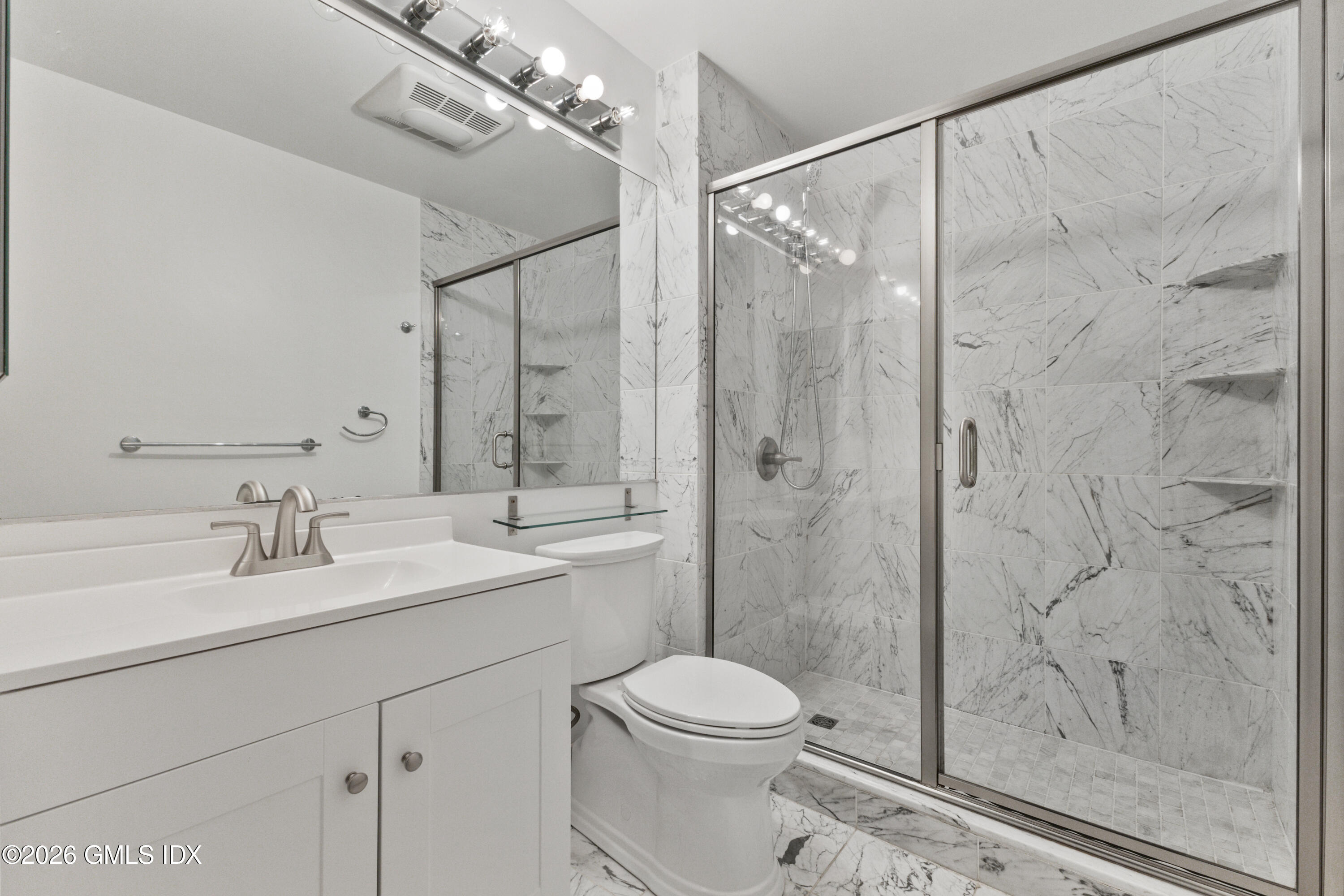 15 River Road, Unit 210 Cos Cob, CT 06807 - Photo 11 of 23 a bathroom with a granite countertop sink a toilet and shower
