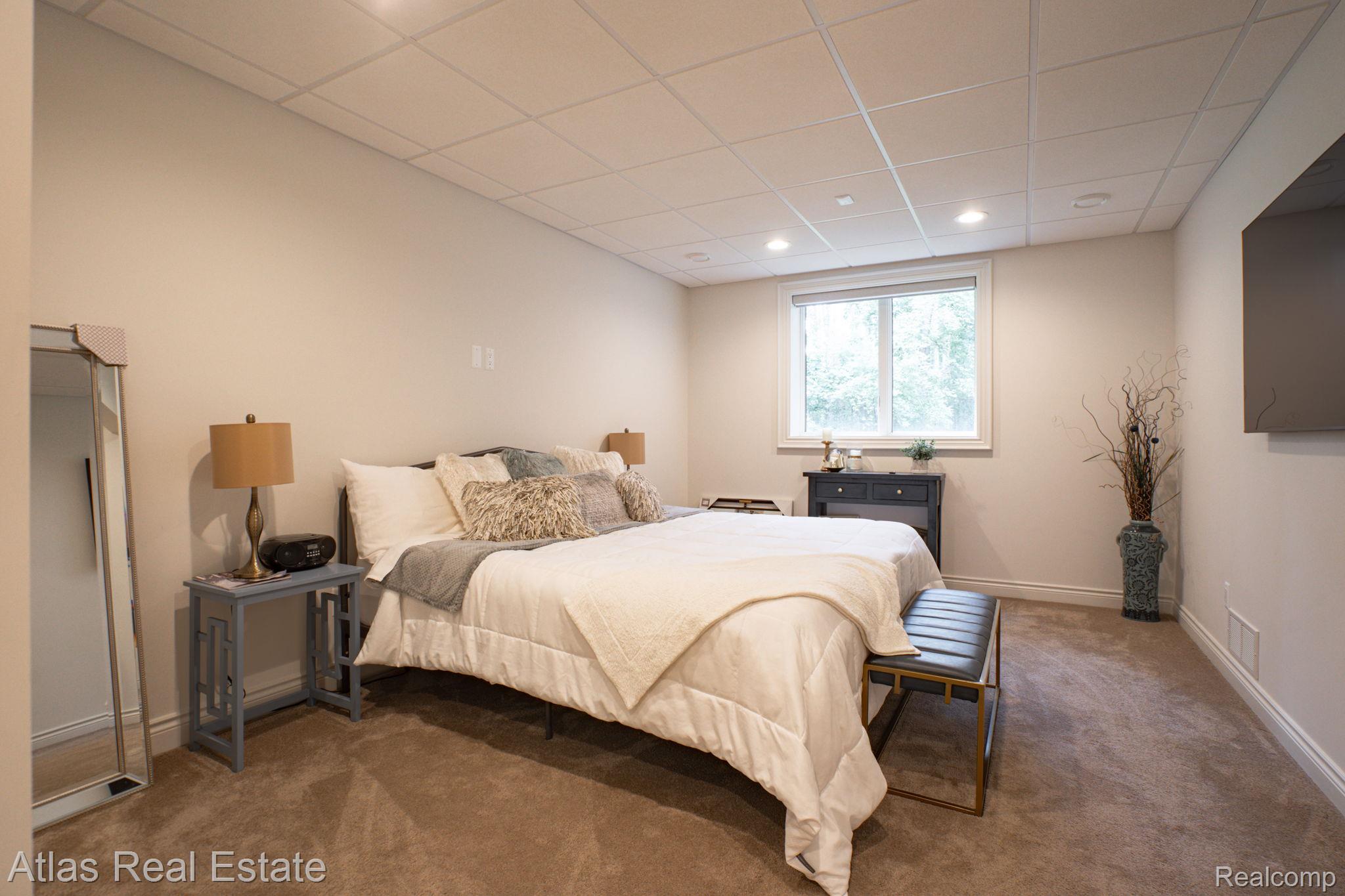 10380 South State Road Goodrich, MI 48438 - Photo 72 of 87 Carpeted room featuring a white window frame, white baseboards, drop ceiling with recessed lighting, and light-toned walls