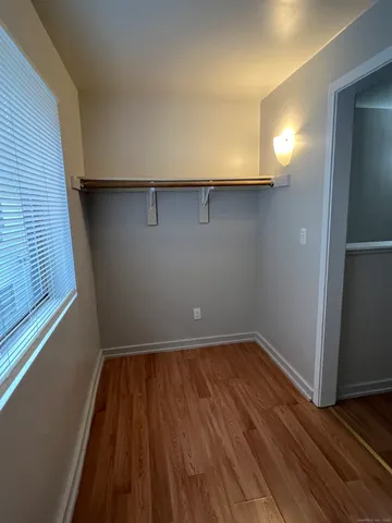 a view of a room with wooden floor and window