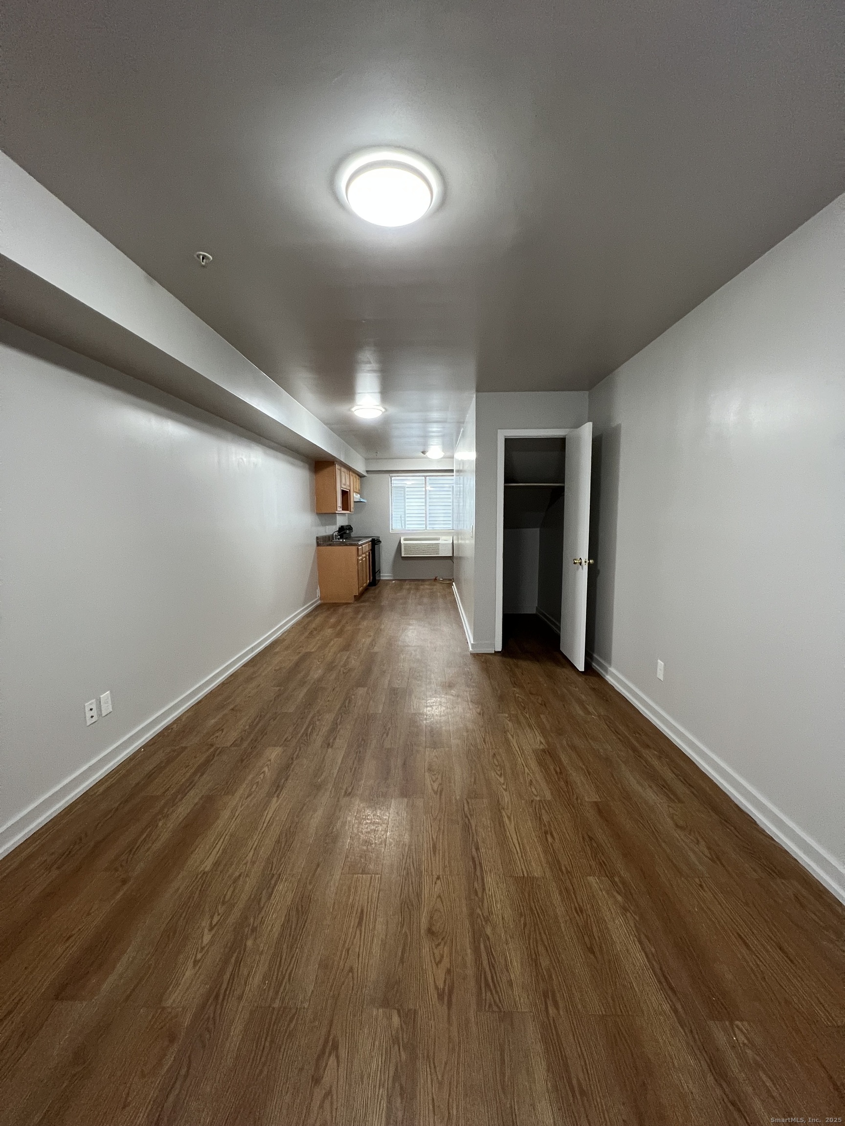 385 Putnam Avenue, Unit 38 Hamden, CT 06517 - Photo 4 of 15 a view of a room with wooden floor and a window
