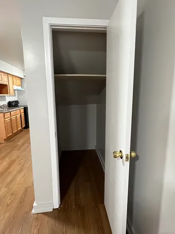 a view of a room with wooden floor