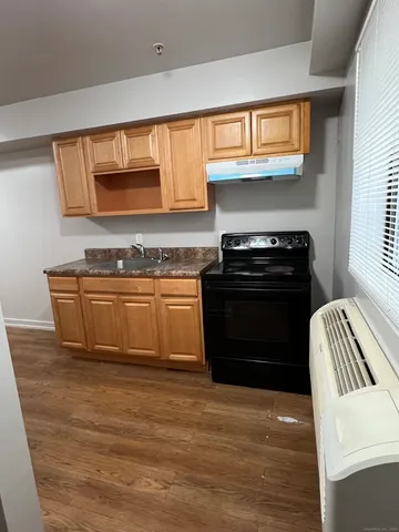 a kitchen with granite countertop a stove and a sink