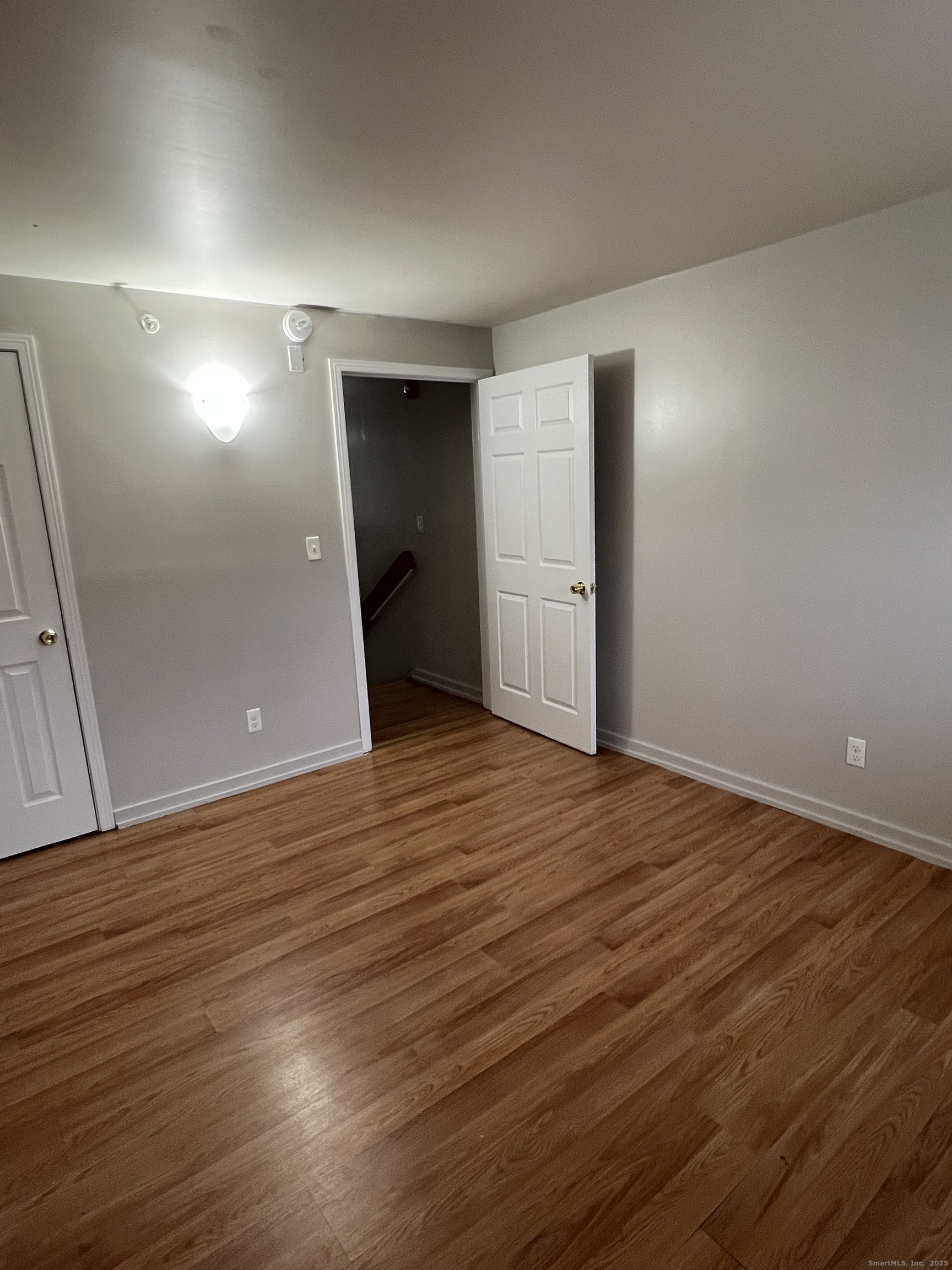 385 Putnam Avenue, Unit 38 Hamden, CT 06517 - Photo 9 of 15 a view of an empty room with wooden floor