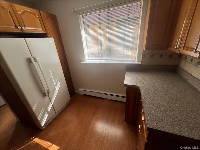 a kitchen with stainless steel appliances granite countertop a sink a stove and a refrigerator