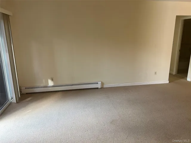 a view of an empty room with a fireplace