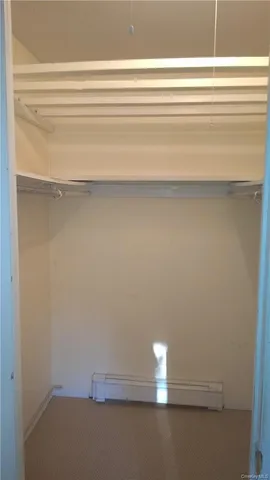 a bathroom with a granite countertop toilet sink and mirror