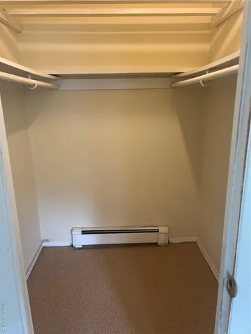 a bathroom with a granite countertop sink toilet and mirror