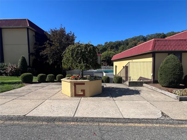a view of a house with backyard and sitting area