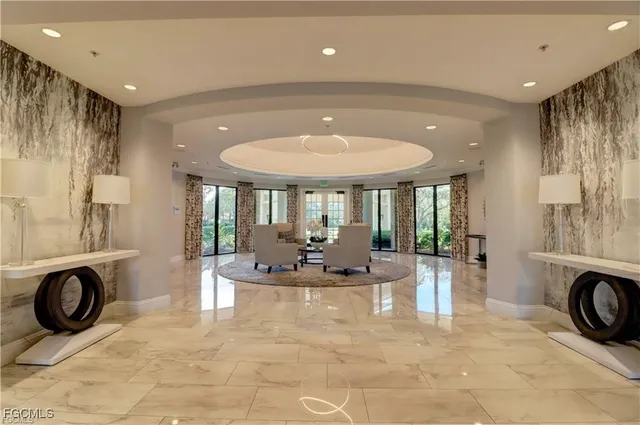 a view of living room with furniture and large windows