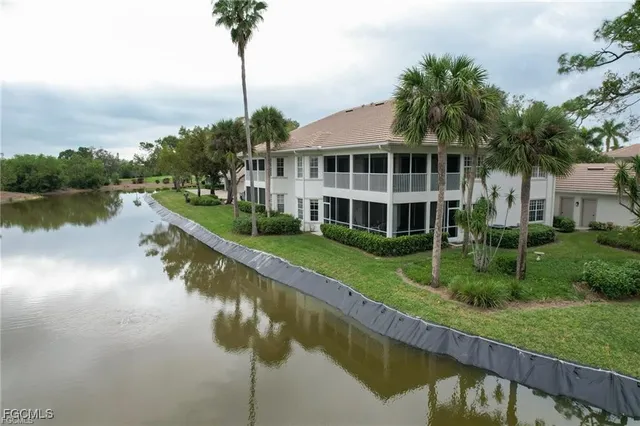 a view of a house with a yard and a fountain