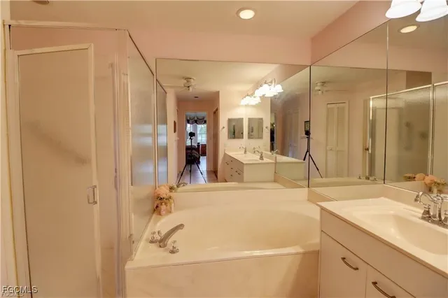 a bathroom with a tub sink and mirror