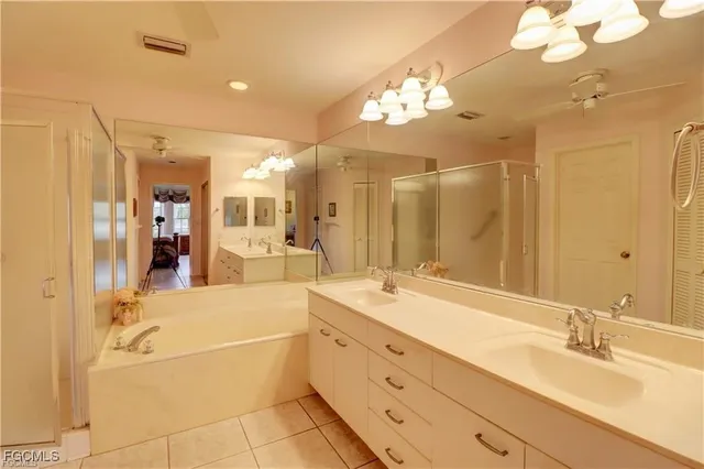 a spacious bathroom with a granite countertop sink mirror and a bath tub