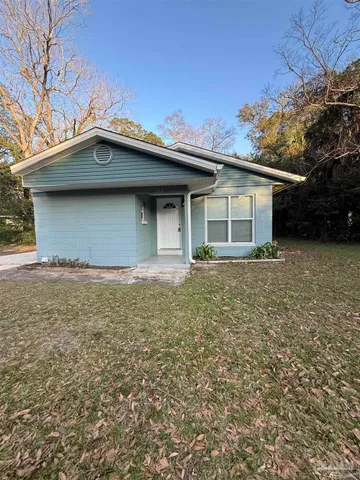 a house with trees in the background