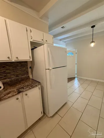 a white refrigerator freezer sitting inside of a kitchen