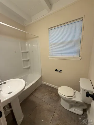 a bathroom with a toilet a sink and bathtub