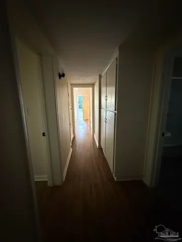 a view of a hallway with wooden floor