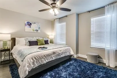 a bedroom with bed and a chandelier