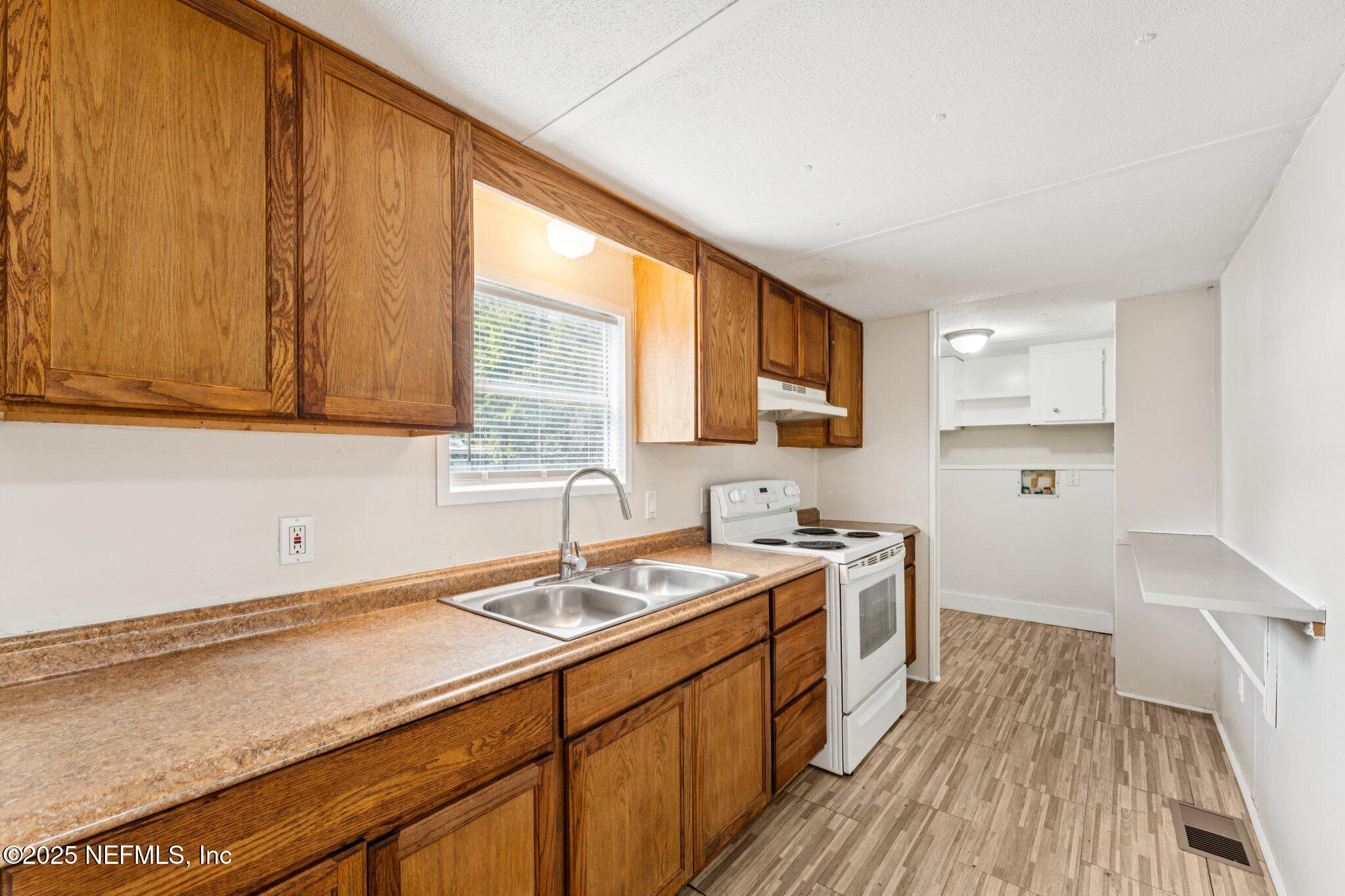 781 Hamilton Avenue St. Augustine, FL 32084 - Photo 13 of 39 a kitchen with a sink stove and cabinets