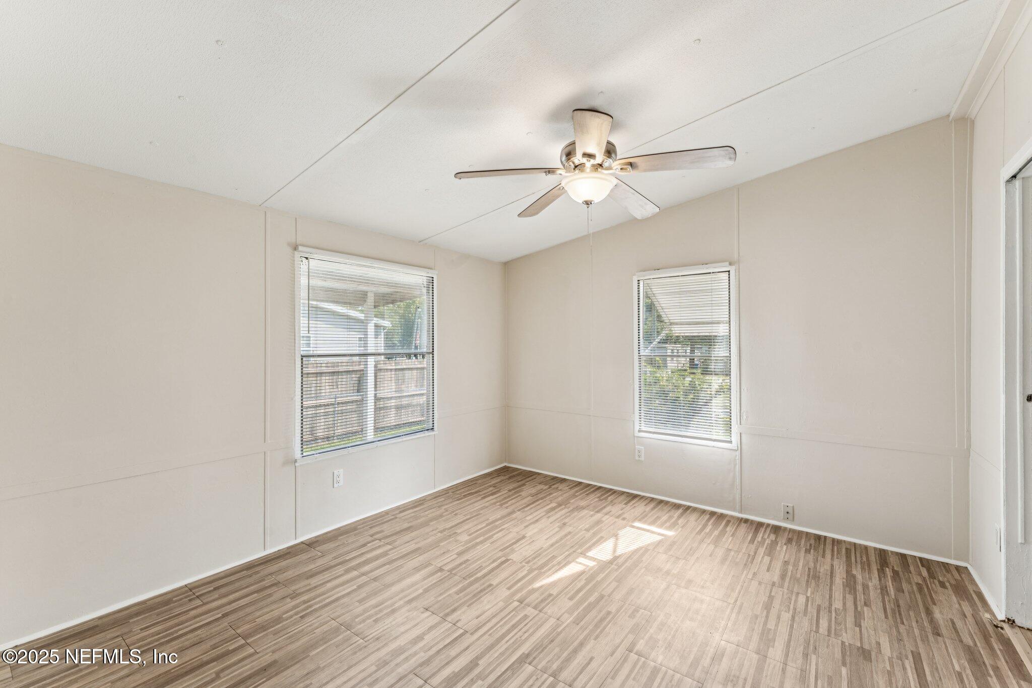781 Hamilton Avenue St. Augustine, FL 32084 - Photo 18 of 39 a view of an empty room with a window and wooden floor