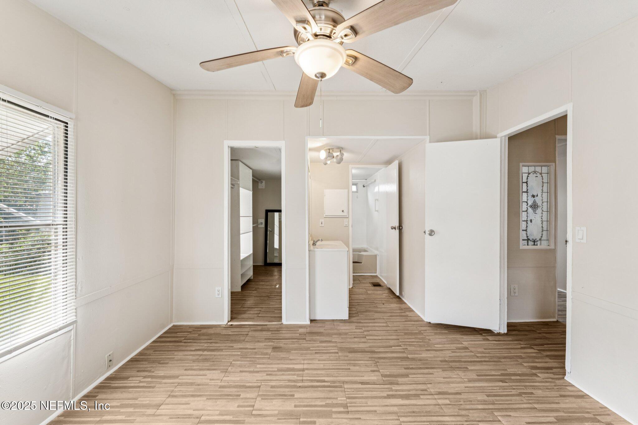 781 Hamilton Avenue St. Augustine, FL 32084 - Photo 23 of 39 a view of a livingroom with a chandelier fan and wooden floor