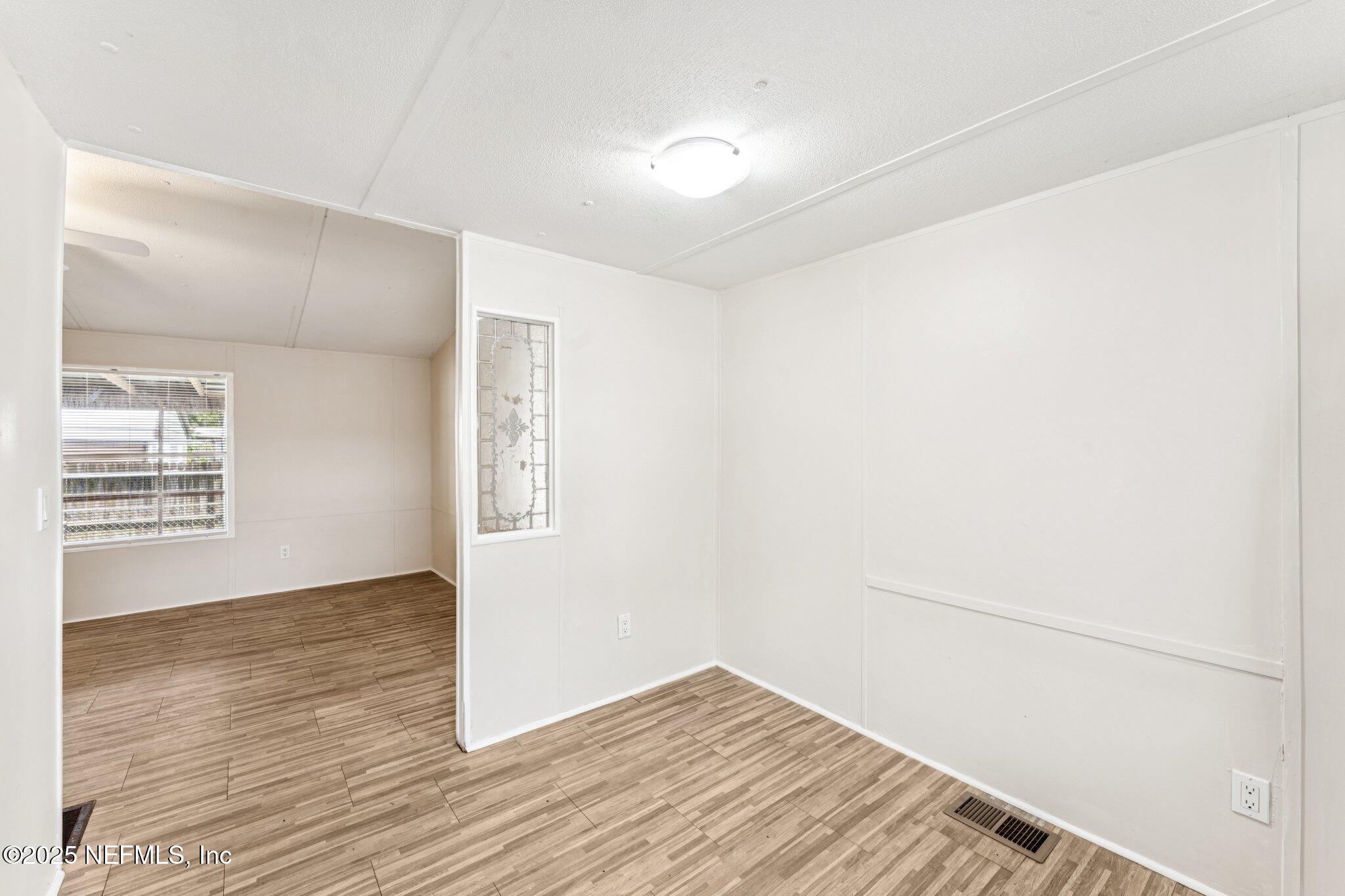 781 Hamilton Avenue St. Augustine, FL 32084 - Photo 24 of 39 a view of an empty room with wooden floor and a window