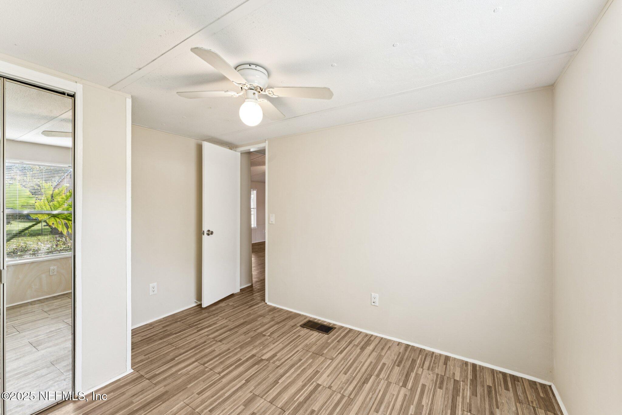 781 Hamilton Avenue St. Augustine, FL 32084 - Photo 28 of 39 an empty room with wooden floor fan and windows