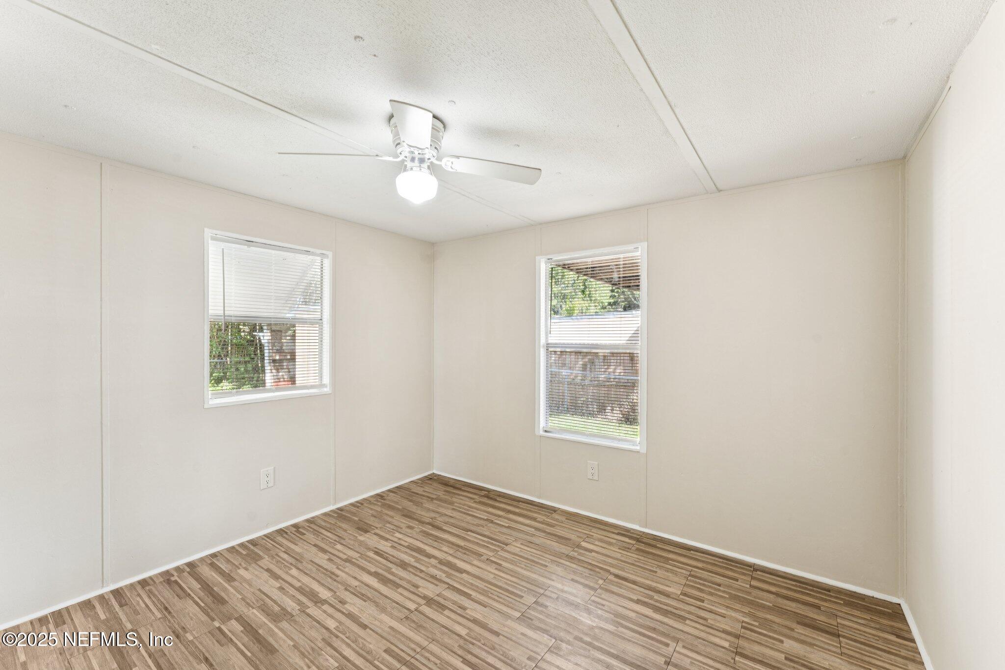 781 Hamilton Avenue St. Augustine, FL 32084 - Photo 29 of 39 a view of an empty room with a window and wooden floor