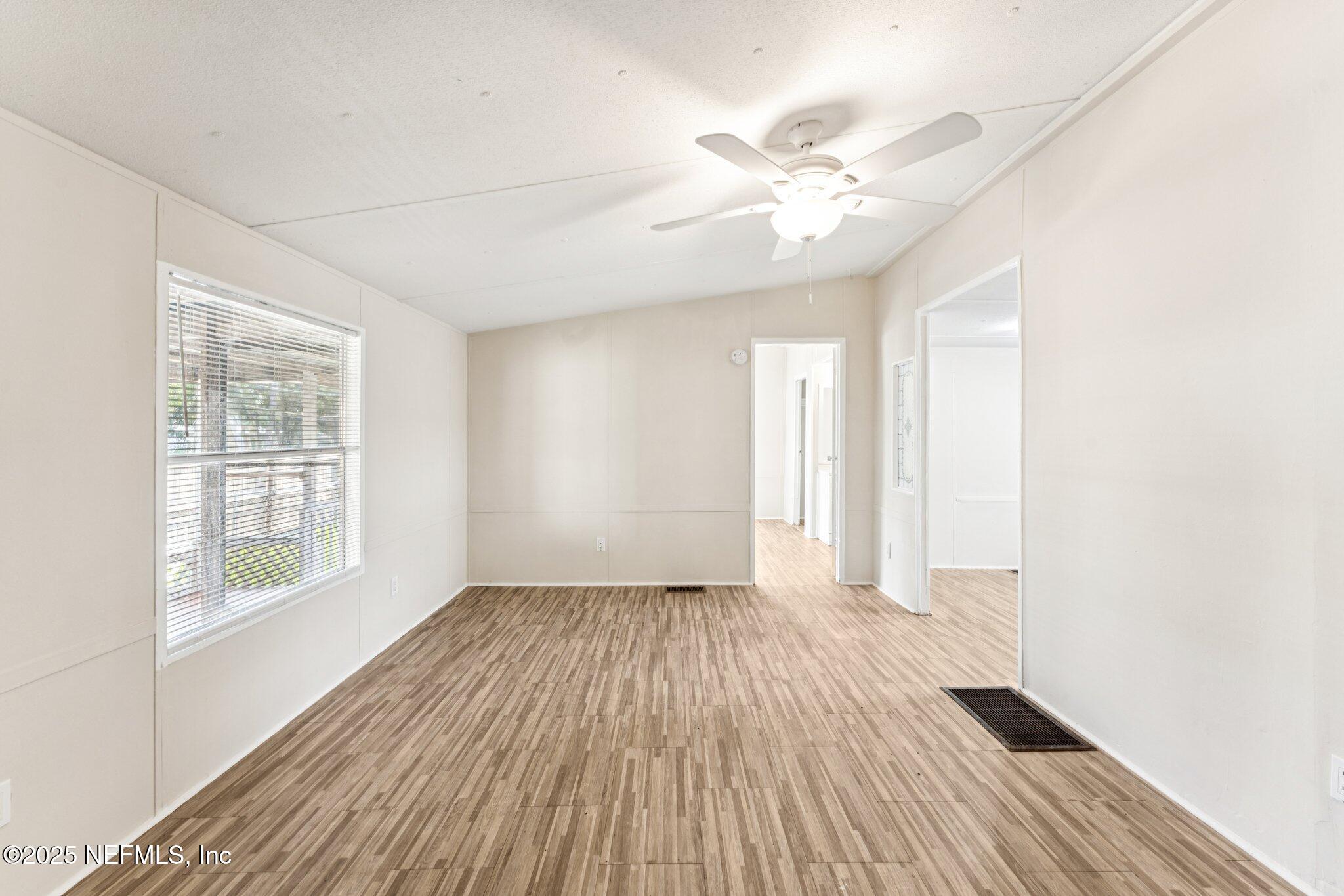 781 Hamilton Avenue St. Augustine, FL 32084 - Photo 31 of 39 an empty room with wooden floor fan and windows